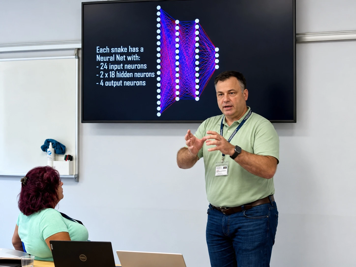 Mykola Latansky explaining a concept during a workshop, with a neural network diagram on the screen behind him.