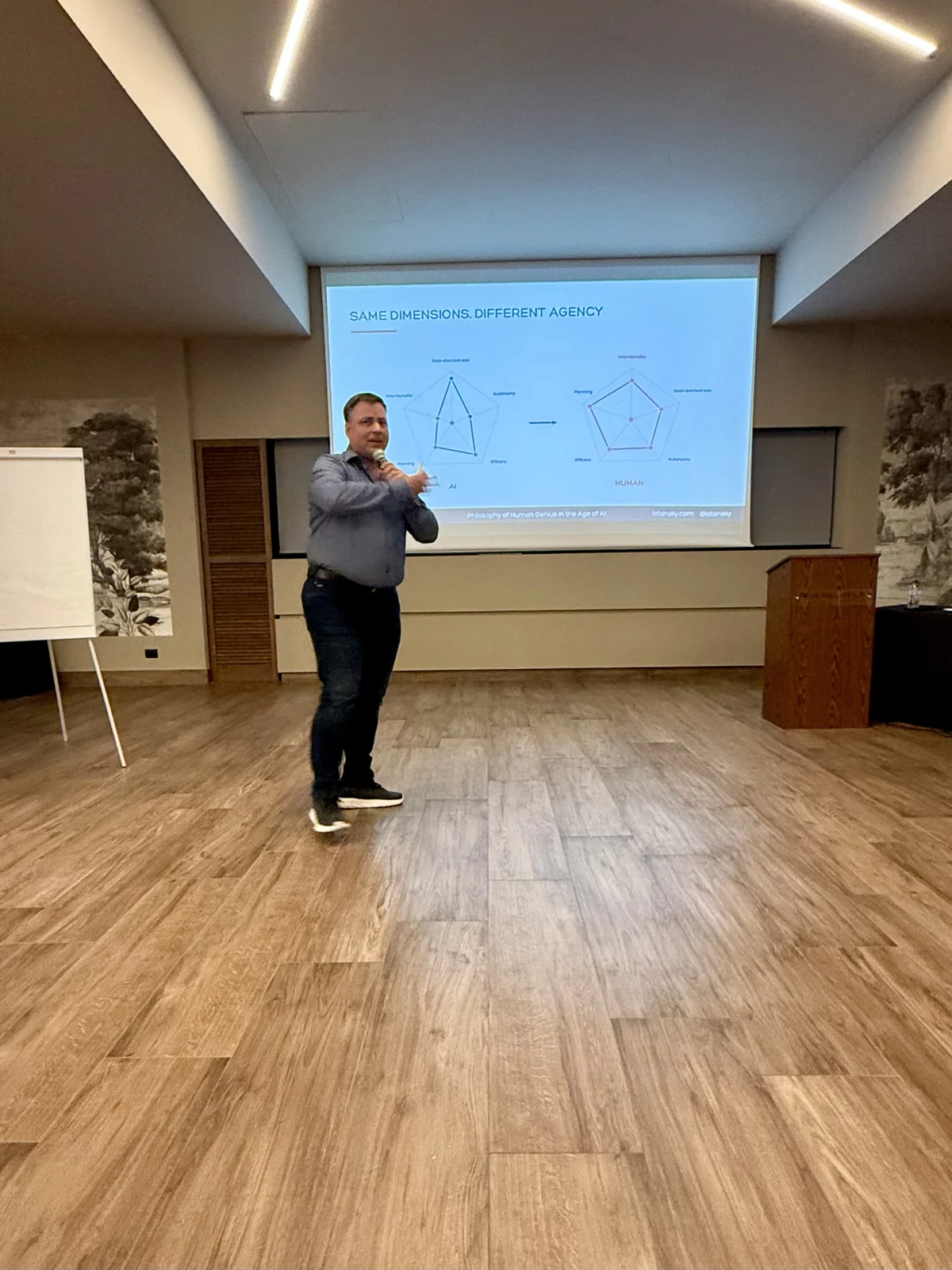 Mykola Latansky presenting ideas on human genius and agency at IAISS 2026