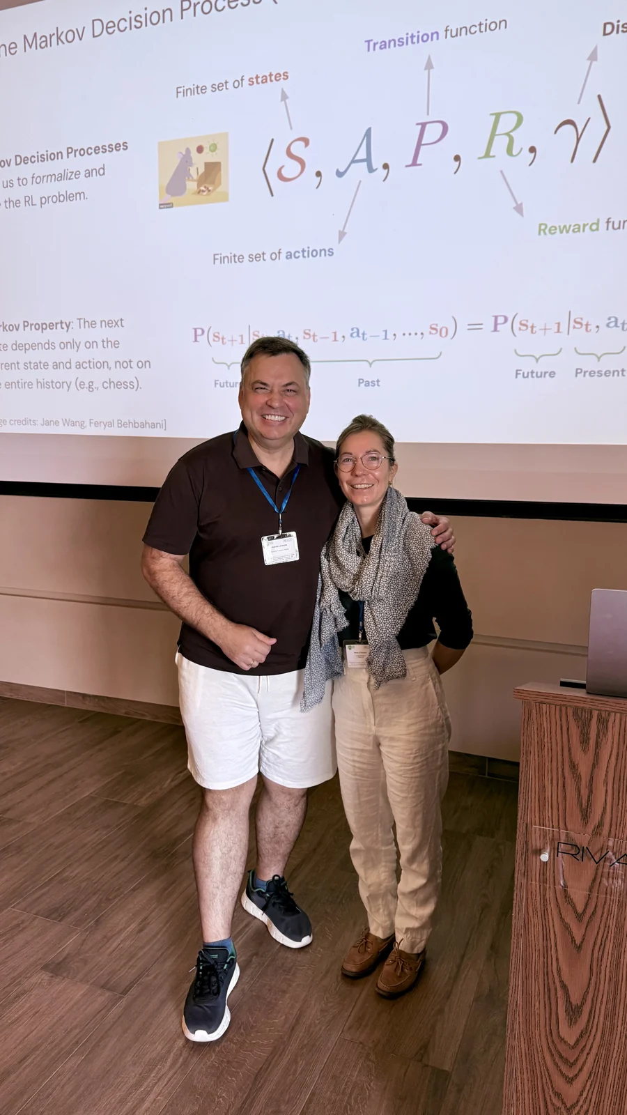 Mykola Latansky with an IAISS 2026 lecturer beside a presentation on decision processes