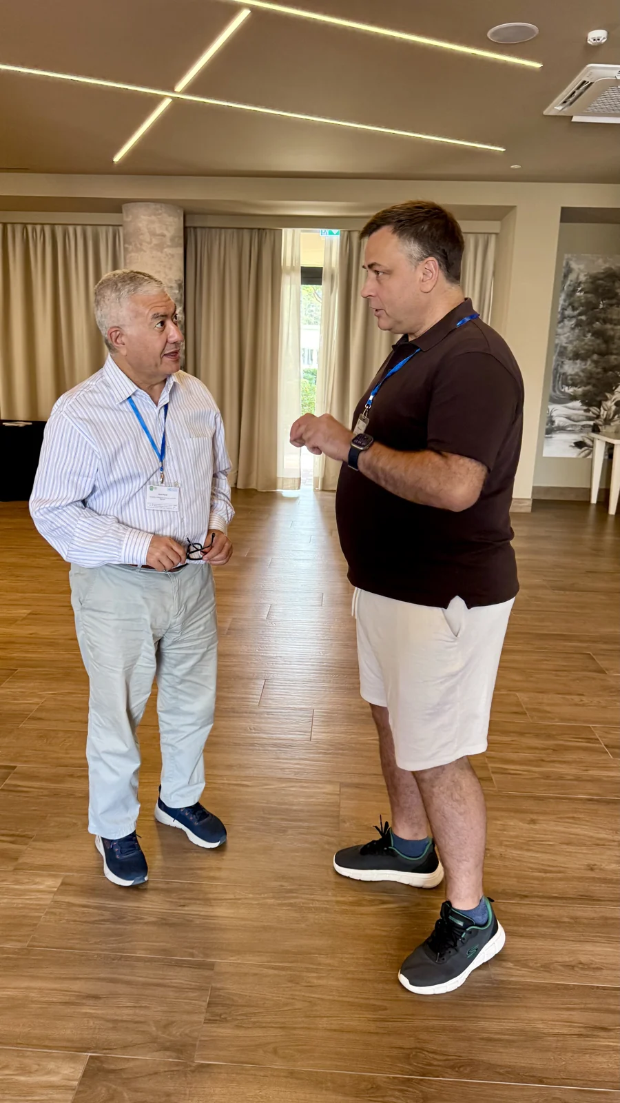 Mykola Latansky discussing AI with a fellow participant at IAISS 2026