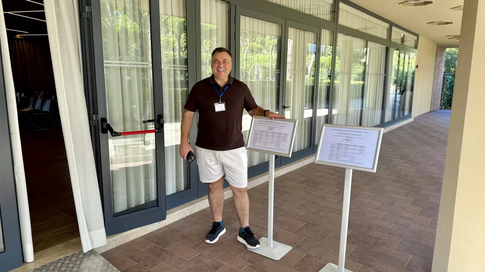 Mykola Latansky beside research posters at IAISS 2026