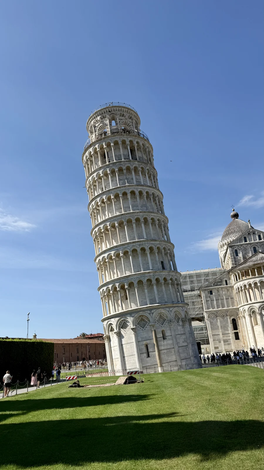 The Leaning Tower of Pisa under a clear blue sky